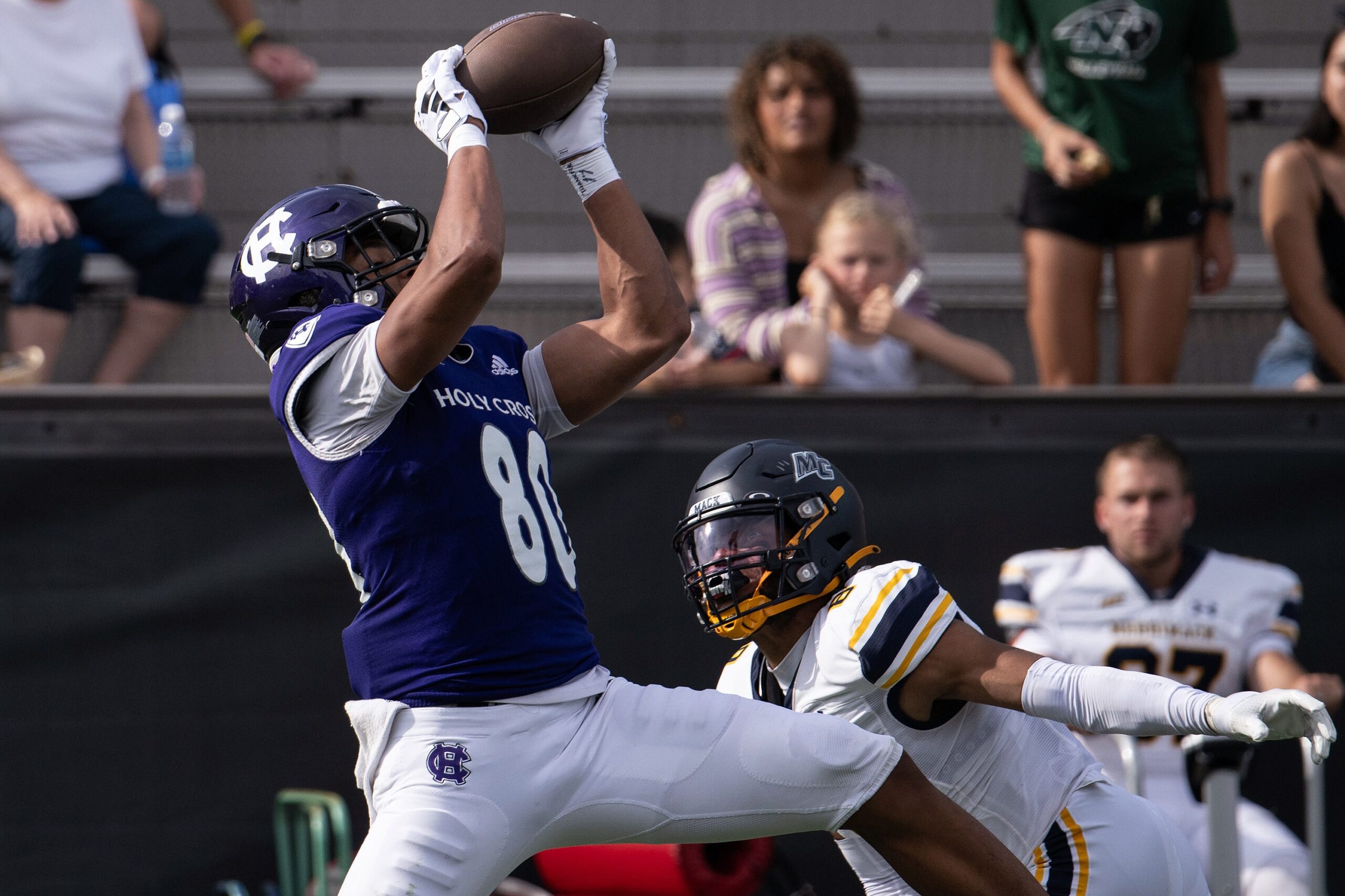 Holy Cross's Jalen Coker hauls in a pass for a first down over Merrimack's Darion McKenzie in the third quarter Saturday at Fitton Field. (Alan Arsenault/USA Today Network)