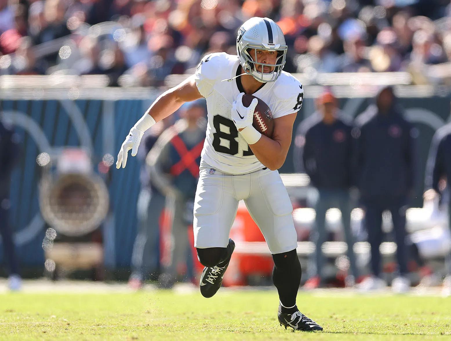 CHICAGO, ILLINOIS - OCTOBER 22: Austin Hooper #81 of the Las Vegas Raiders runs with the ball after a reception against the Chicago Bears at Soldier Field on October 22, 2023 in Chicago, Illinois. (Photo by Michael Reaves/Getty Images)