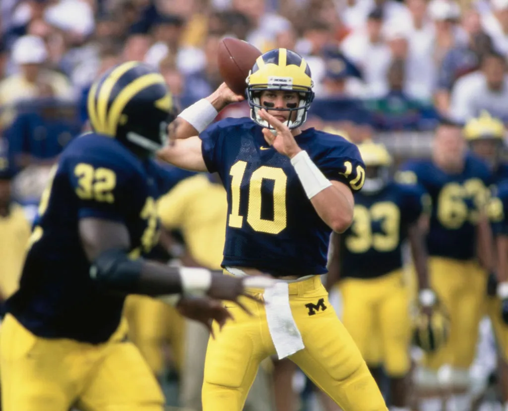 Tom Brady #10, Quarterback for the University of Michigan Wolverines prepares to throw a pass to Running Back #32 Anthony Thomas during the NCAA Big 10 Conference college football game against the Michigan State Spartans on 26th September 1998 at the Michigan Stadium in Ann Arbor, Michigan, United States. Michigan Wolverines won the game 29 - 17. (Photo by Rick Stewart/Allsport/Getty Images)