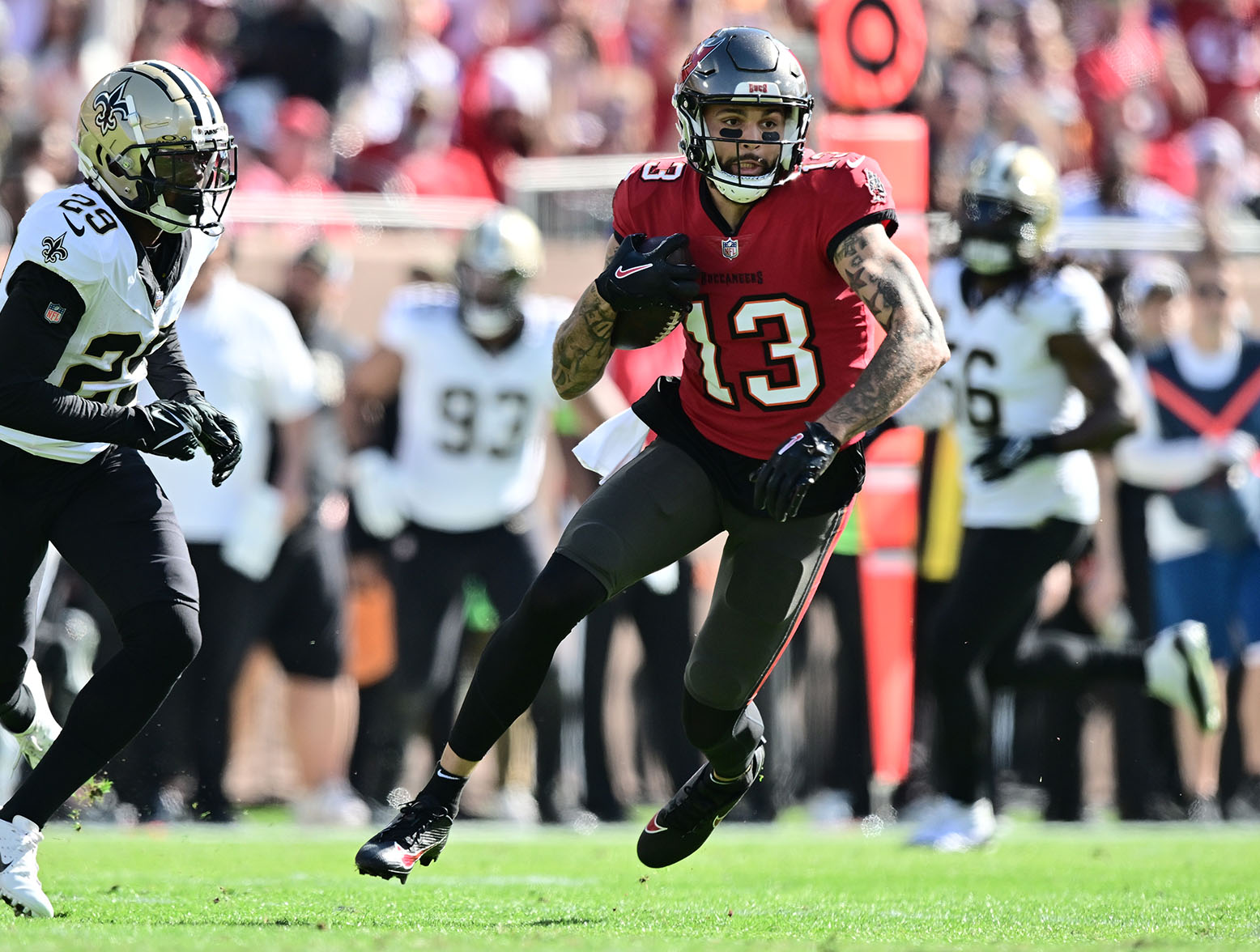 TAMPA, FLORIDA - DECEMBER 31: Mike Evans #13 of the Tampa Bay Buccaneers runs with the ball during the first quarter against the New Orleans Saints at Raymond James Stadium on December 31, 2023 in Tampa, Florida. (Photo by Julio Aguilar/Getty Images)
