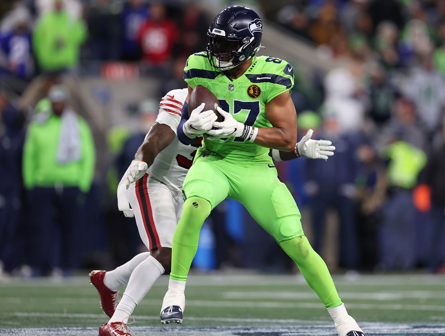 SEATTLE, WASHINGTON - NOVEMBER 23: Noah Fant #87 of the Seattle Seahawks runs with the ball during the fourth quarter against the San Francisco 49ers at Lumen Field on November 23, 2023 in Seattle, Washington. (Photo by Steph Chambers/Getty Images)