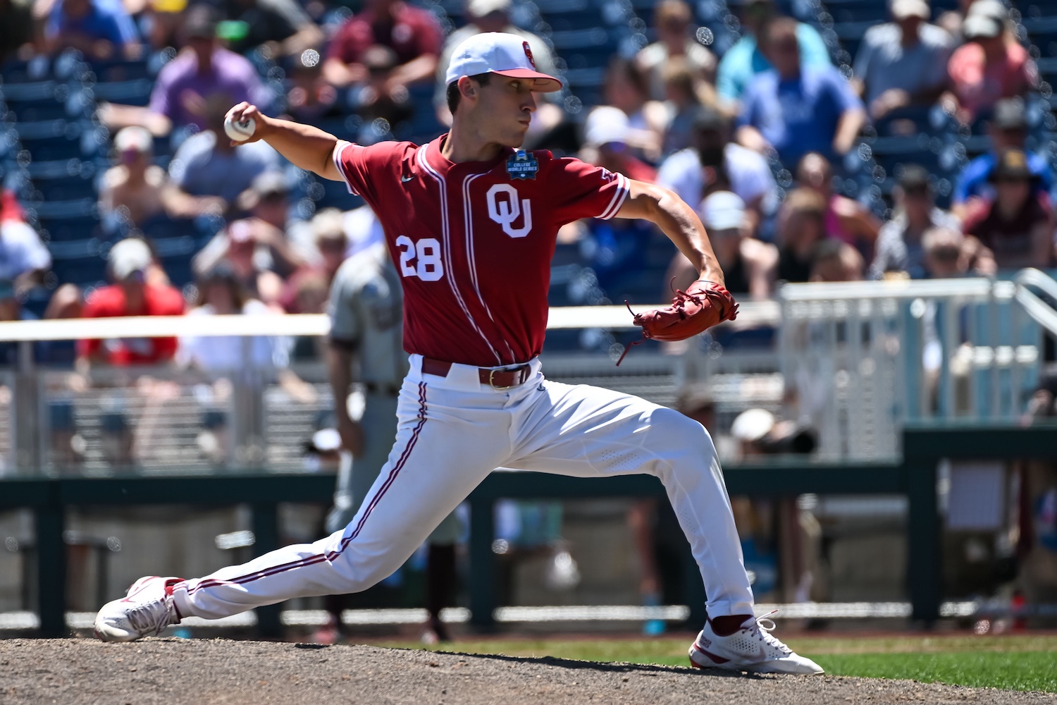 Jun 22, 2022; Omaha, NE, USA; Oklahoma Sooners starting pitcher David Sandlin (28) throws in the fourth inning against the Texas A&M Aggies at Charles Schwab Field. Mandatory Credit: Steven Branscombe-USA TODAY Sports