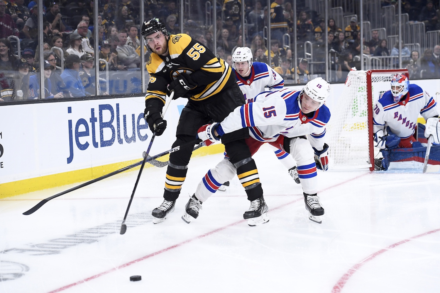 Sep 27, 2022; Boston, Massachusetts, USA;  Boston Bruins forward Justin Brazeau (55) passes the puck past New York Rangers center Gustav Rydahl (15) during the third period at TD Garden. Mandatory Credit: Bob DeChiara-USA TODAY Sports