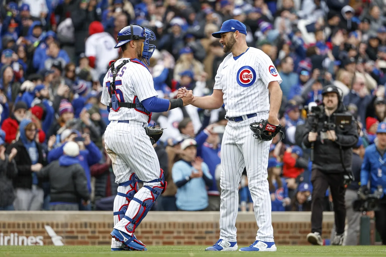 Mar 30, 2023; Chicago, Illinois, USA; Chicago Cubs relief pitcher Michael Fulmer (32) celebrates with catcher Yan Gomes (15) team's win against the Milwaukee Brewers at Wrigley Field. Mandatory Credit: Kamil Krzaczynski-USA TODAY Sports