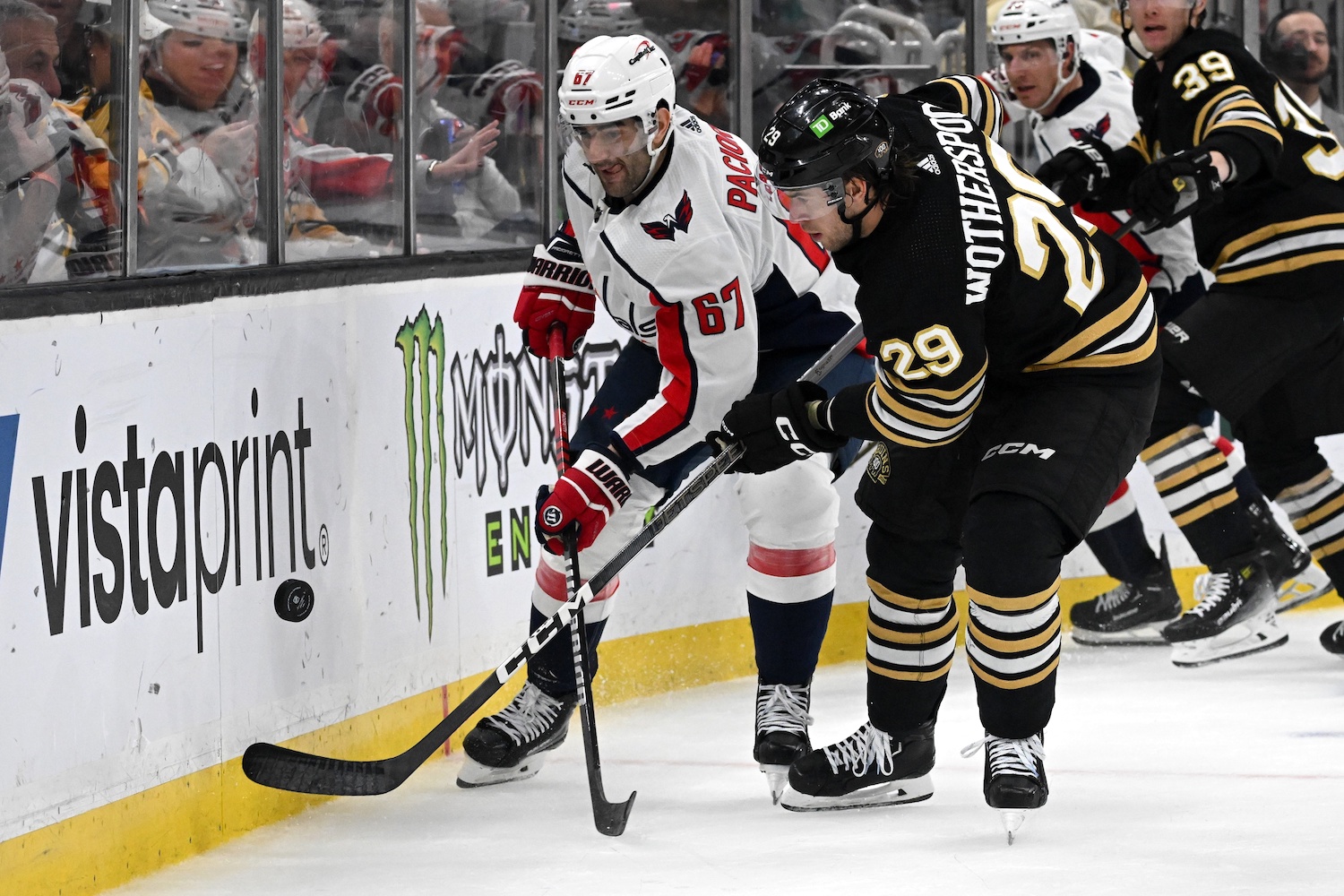 Feb 10, 2024; Boston, Massachusetts, USA; Washington Capitals left wing Max Pacioretty (67) and Boston Bruins defenseman Derek Forbort (28) battle for the puck during the second period at the TD Garden. Mandatory Credit: Brian Fluharty-USA TODAY Sports