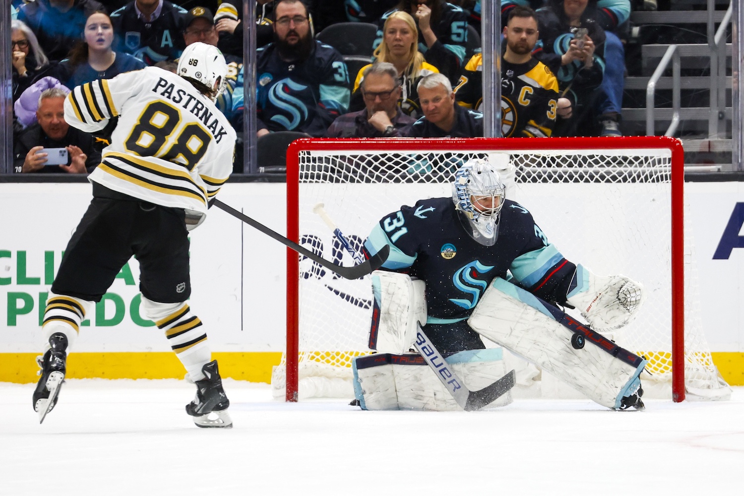 Feb 26, 2024; Seattle, Washington, USA; Seattle Kraken goaltender Philipp Grubauer (31) makes a save against Boston Bruins right wing David Pastrnak (88) during an overtime shootout at Climate Pledge Arena. Mandatory Credit: Joe Nicholson-USA TODAY Sports