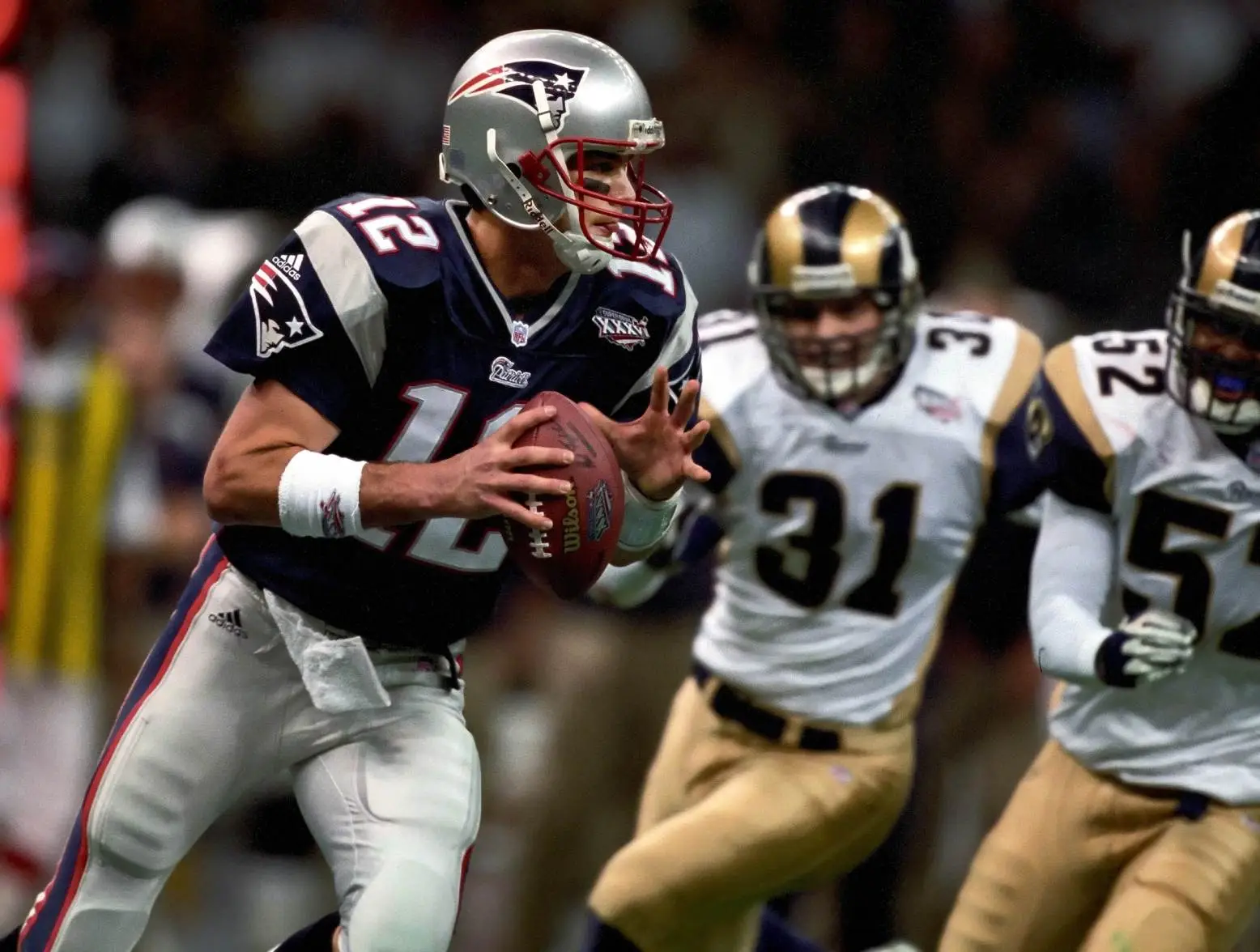 Feb 3, 2002; New Orleans, LA, USA; New England Patriots quarterback Tom Brady (12) in action against the St. Louis Rams during Super Bowl XXXVI at the Louisiana Superdome. The Patriots defeated the Rams 20-17. Credit: USA TODAY Sports