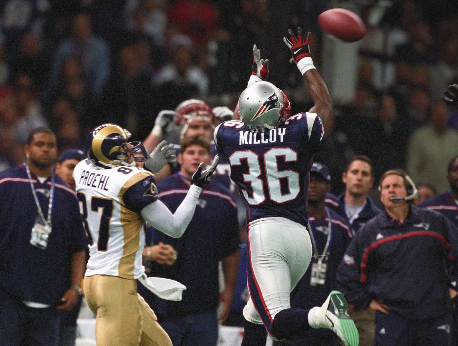Feb 3, 2002; New Orleans, LA, USA; New England Patriots defensive back Lawyer Milloy (36) and St. Louis Rams receiver Ricky Proehl (87) go up for a pass during Super Bowl XXXVI at the Louisiana Superdome. The Patriots defeated the Rams 20-17. Credit: USA TODAY Sports
