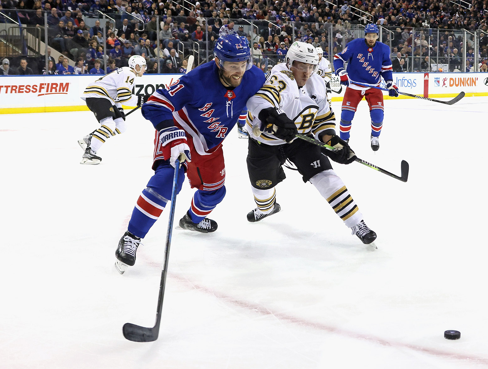 NEW YORK, NEW YORK - NOVEMBER 25: Barclay Goodrow #21 of the New York Rangers and Brad Marchand #63 of the Boston Bruins battle at Madison Square Garden on November 25, 2023 in New York City. (Photo by Bruce Bennett/Getty Images)