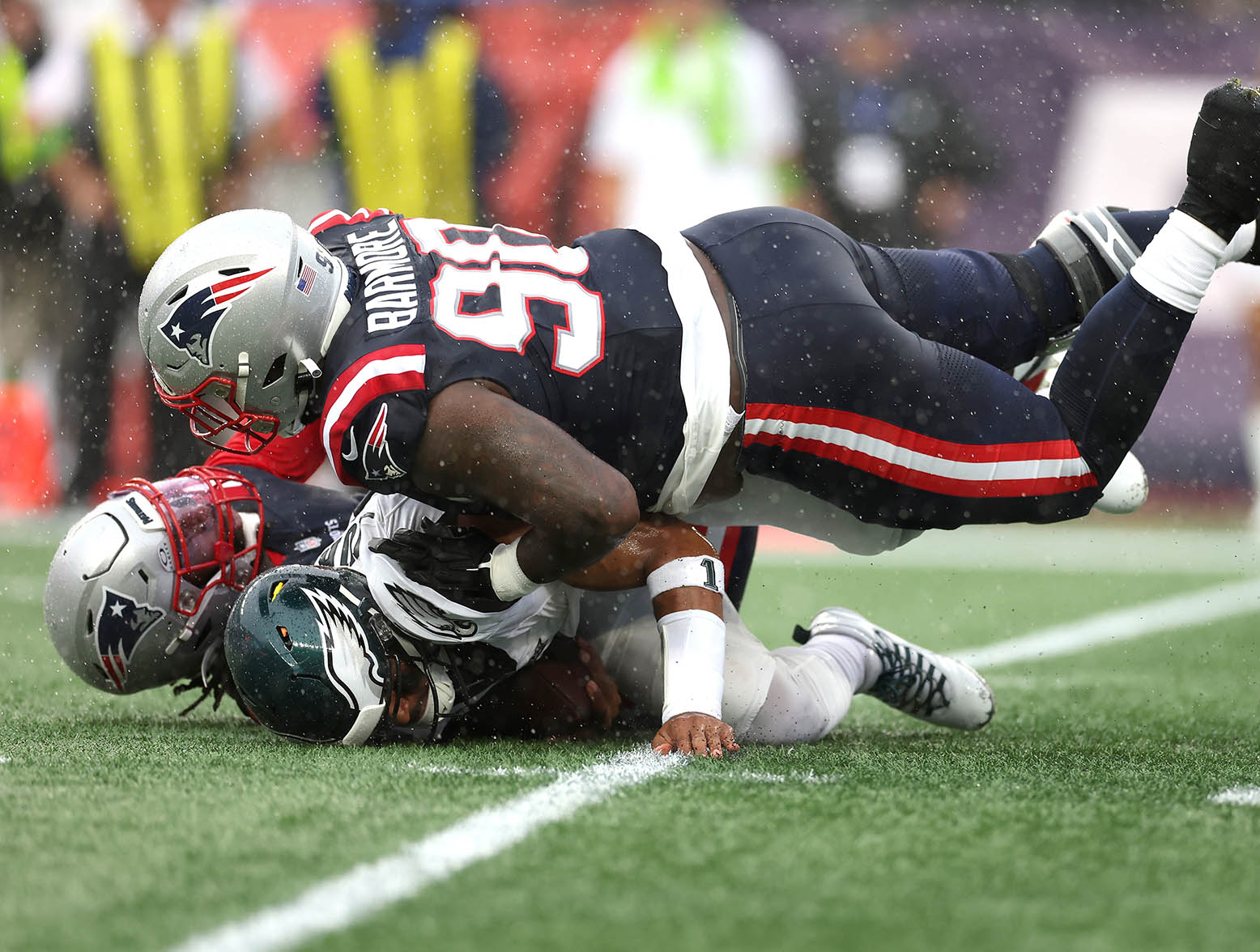 FOXBOROUGH, MASSACHUSETTS - SEPTEMBER 10: Matthew Judon #9 of the New England Patriots and Christian Barmore #90 of the New England Patriots sack Jalen Hurts #1 of the Philadelphia Eagles during the first quarter at Gillette Stadium on September 10, 2023 in Foxborough, Massachusetts. (Photo by Maddie Meyer/Getty Images)