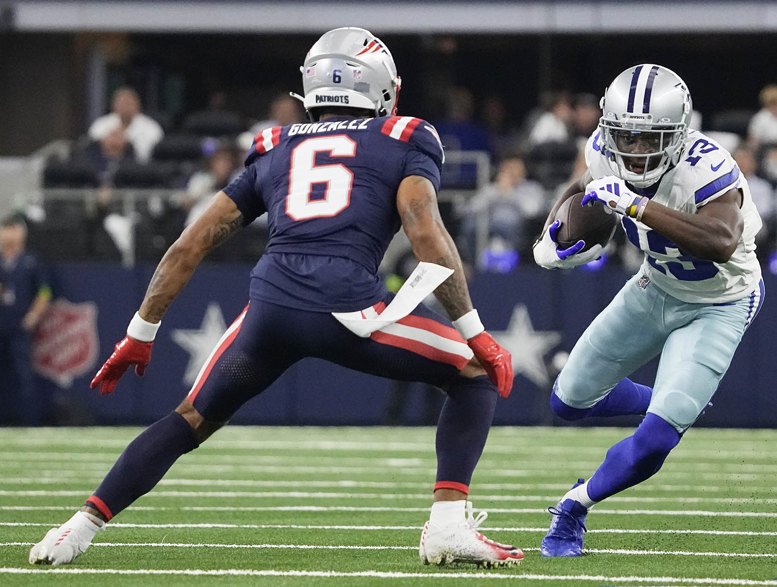 ARLINGTON, TEXAS - OCTOBER 01: Christian Gonzalez #6 of the New England Patriots attempts to tackle Michael Gallup #13 of the Dallas Cowboys during the first quarter at AT&T Stadium on October 01, 2023 in Arlington, Texas. (Photo by Sam Hodde/Getty Images)