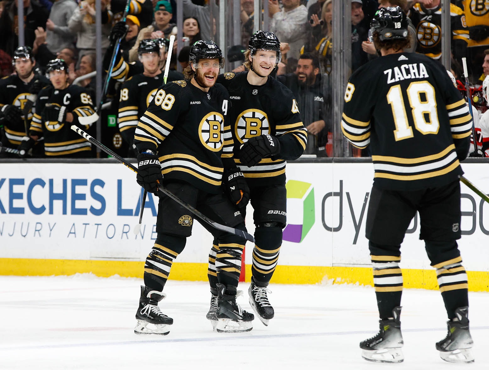 BOSTON, MASSACHUSETTS - MARCH 19: David Pastrnak #88 of the Boston Bruins celebrates his hat trick against the Ottawa Senators with teammate Danton Heinen #43 during the third period at the TD Garden on March 19, 2024 in Boston, Massachusetts. (Photo by Rich Gagnon/Getty Images)