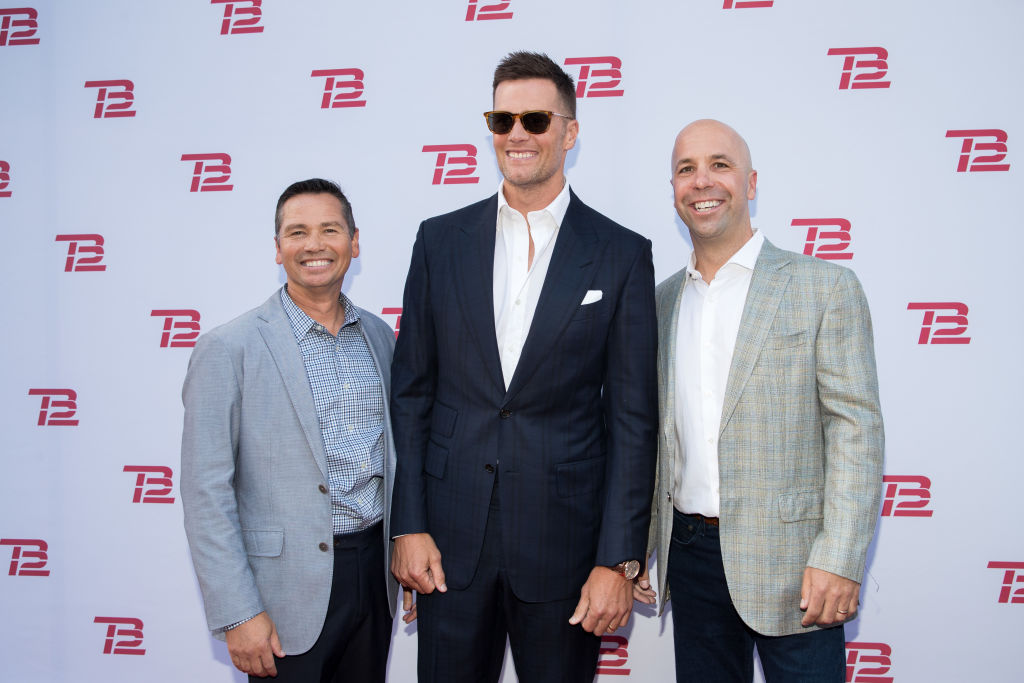 BOSTON, MA - SEPTEMBER 17:  Alex Guerrero, left to right, co-founder of TB12 Performance & Fitness, New England Patriots player Tom Brady and John Burns, CEO of TB12 Performance & Fitness at the grand opening of the TB12 Performance & Recovery Center on September 17, 2019 in Boston, Massachusetts.  (Photo by Scott Eisen/Getty Images)