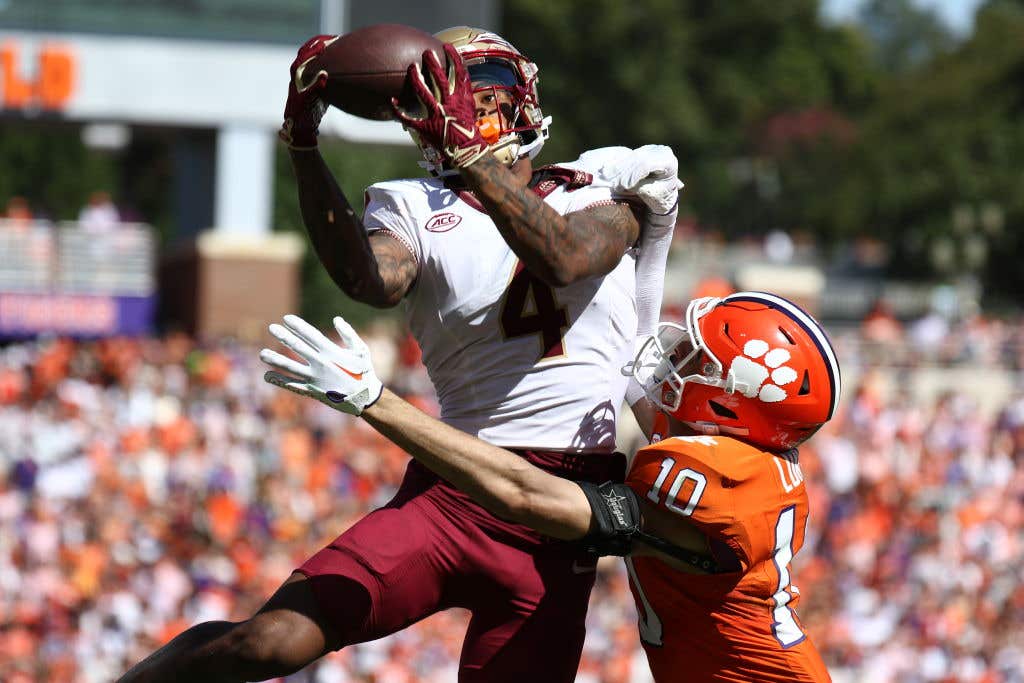 CLEMSON, SOUTH CAROLINA - SEPTEMBER 23: Keon Coleman #4 of the Florida State Seminoles makes the game-winning catch against Jeadyn Lukus #10 of the Clemson Tigers in overtime at Memorial Stadium on September 23, 2023 in Clemson, South Carolina. (Photo by Isaiah Vazquez/Getty Images)