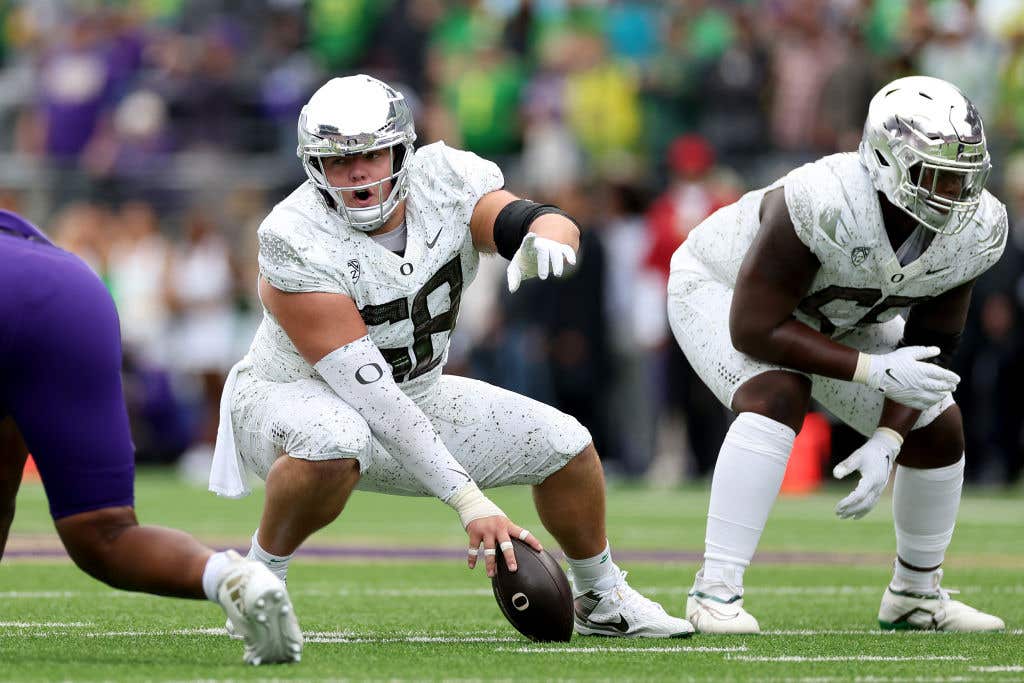 SEATTLE, WASHINGTON - OCTOBER 14: Jackson Powers-Johnson #58 of the Oregon Ducks prepares for a snap against the Washington Huskies at Husky Stadium on October 14, 2023 in Seattle, Washington. (Photo by Steph Chambers/Getty Images)