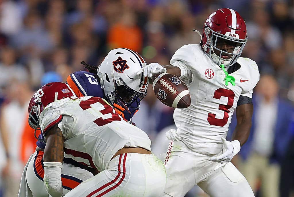 AUBURN, ALABAMA - NOVEMBER 25: Rivaldo Fairweather #13 of the Auburn Tigers fails to pull in this reception as he is hit by Jihaad Campbell #30 and Terrion Arnold #3 of the Alabama Crimson Tide during the fourth quarter at Jordan-Hare Stadium on November 25, 2023 in Auburn, Alabama. (Photo by Kevin C. Cox/Getty Images)