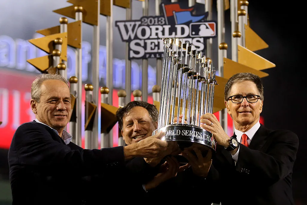 BOSTON, MA - OCTOBER 30: Owner of the Boston Red Sox John Henry is presented with the trophy after the Boston Red Sox defeated the St. Louis Cardinals 6-1 in Game Six of the 2013 World Series at Fenway Park on October 30, 2013 in Boston, Massachusetts. (Photo by Rob Carr/Getty Images)