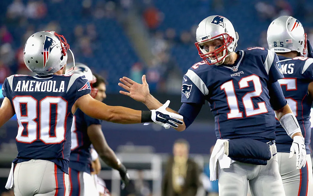 FOXBORO, MA - OCTOBER 29:  Tom Brady #12 of the New England Patriots high fives Danny Amendola #80 before a game against the Miami Dolphins at Gillette Stadium on October 29, 2015 in Foxboro, Massachusetts.  (Photo by Jim Rogash/Getty Images)