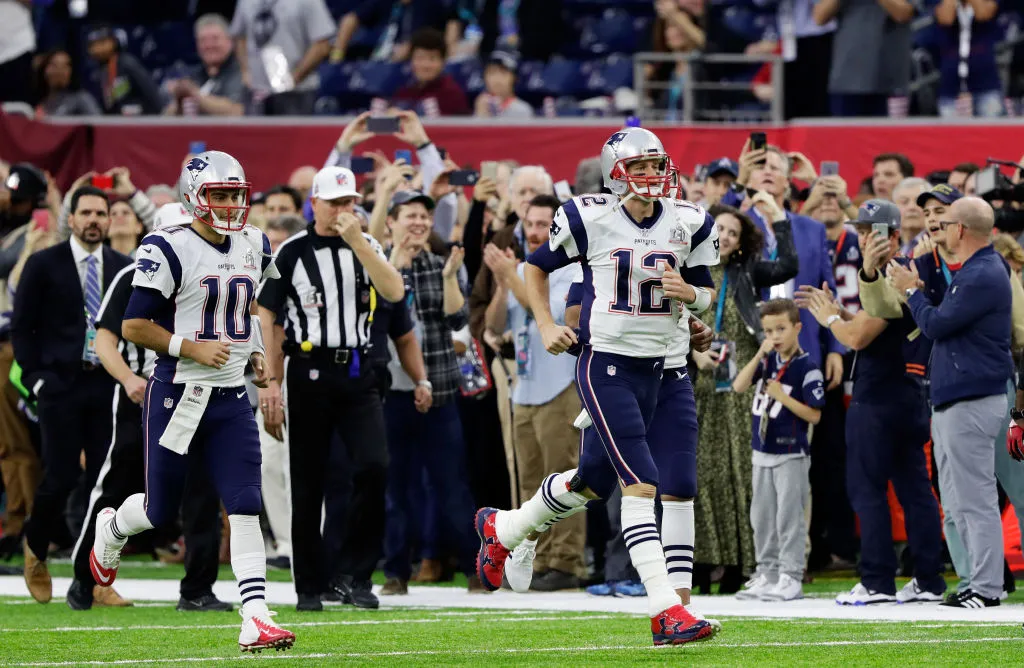 HOUSTON, TX - FEBRUARY 05: Jimmy Garoppolo #10 and Tom Brady #12 of the New England Patriots run onto the field prior to Super Bowl 51 against the Atlanta Falcons at NRG Stadium on February 5, 2017 in Houston, Texas. (Photo by Jamie Squire/Getty Images)