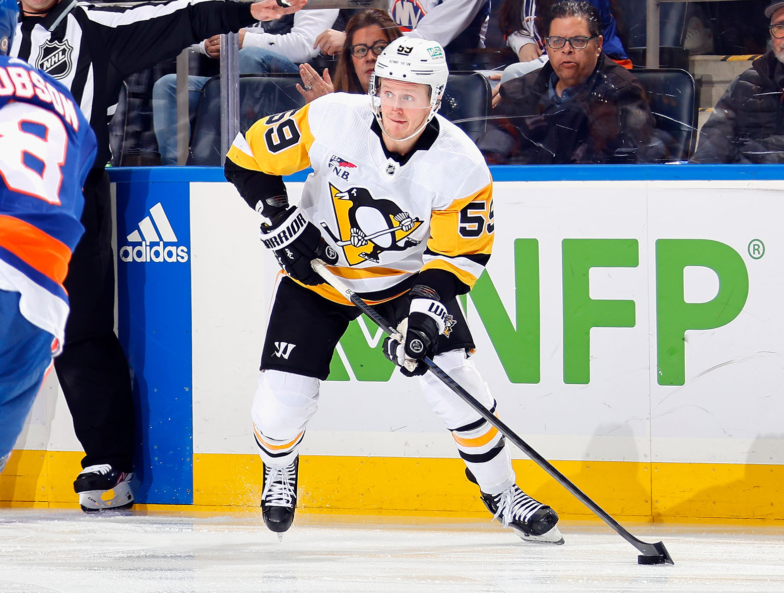 ELMONT, NEW YORK - DECEMBER 27: Jake Guentzel #59 of the Pittsburgh Penguins skates against the New York Islanders at UBS Arena on December 27, 2023 in Elmont, New York. (Photo by Bruce Bennett/Getty Images)