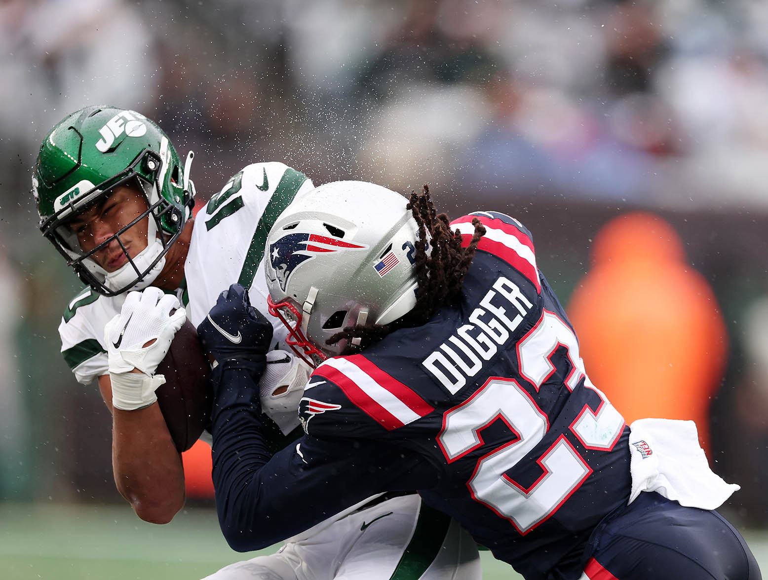 EAST RUTHERFORD, NEW JERSEY - SEPTEMBER 24: Allen Lazard #10 of the New York Jets is tackled by Kyle Dugger #23 of the New England Patriots at MetLife Stadium on September 24, 2023 in East Rutherford, New Jersey. (Photo by Al Bello/Getty Images)