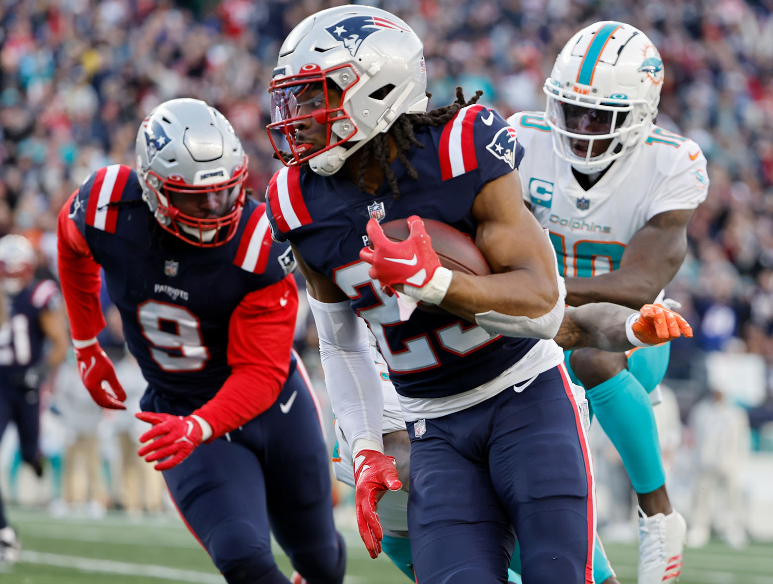 FOXBOROUGH, MASSACHUSETTS - JANUARY 01: Kyle Dugger #23 of the New England Patriots runs back an interception for a touchdown against the Miami Dolphins during the third quarter at Gillette Stadium on January 01, 2023 in Foxborough, Massachusetts. (Photo by Winslow Townson/Getty Images)