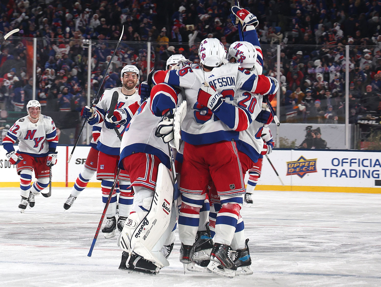 EAST RUTHERFORD, NEW JERSEY - FEBRUARY 18: The New York Rangers celebrate their 6-5 overtime win against the New York Islanders during the 2024 Navy Federal Credit Union Stadium Series at MetLife Stadium on February 18, 2024 in East Rutherford, New Jersey. (Photo by Al Bello/Getty Images)