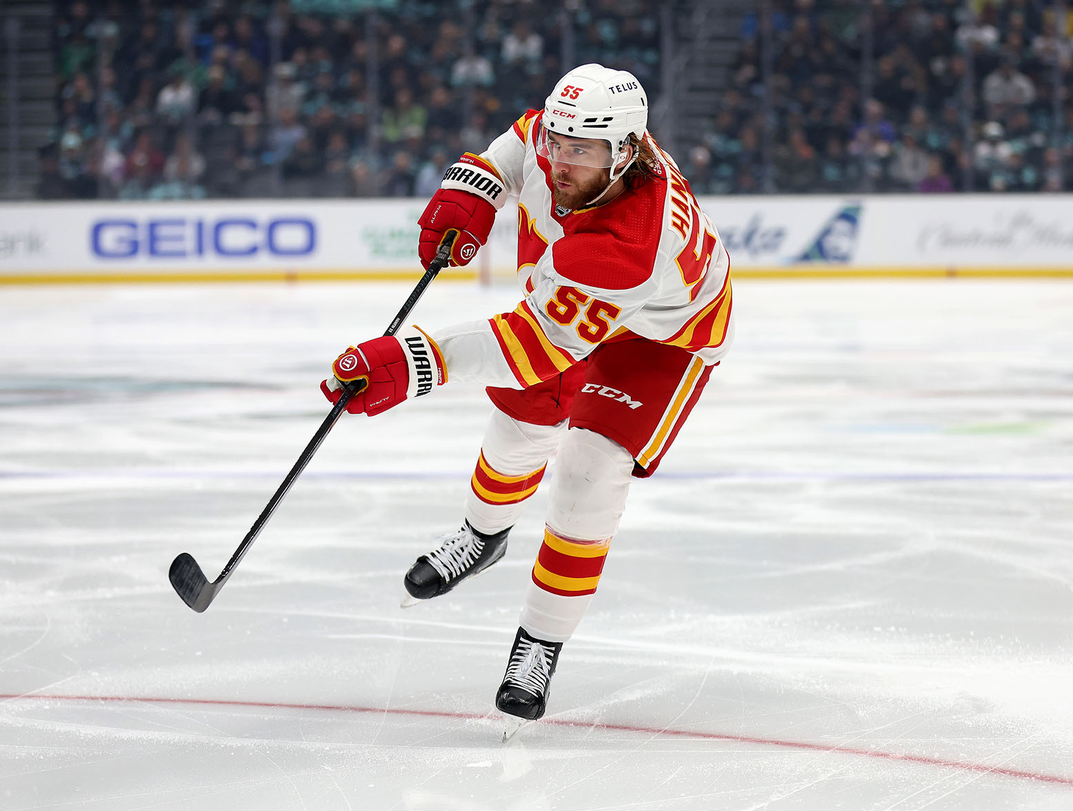 SEATTLE, WASHINGTON - NOVEMBER 20: Noah Hanifin #55 of the Calgary Flames shoots against the Seattle Kraken during the first period at Climate Pledge Arena on November 20, 2023 in Seattle, Washington. (Photo by Steph Chambers/Getty Images)