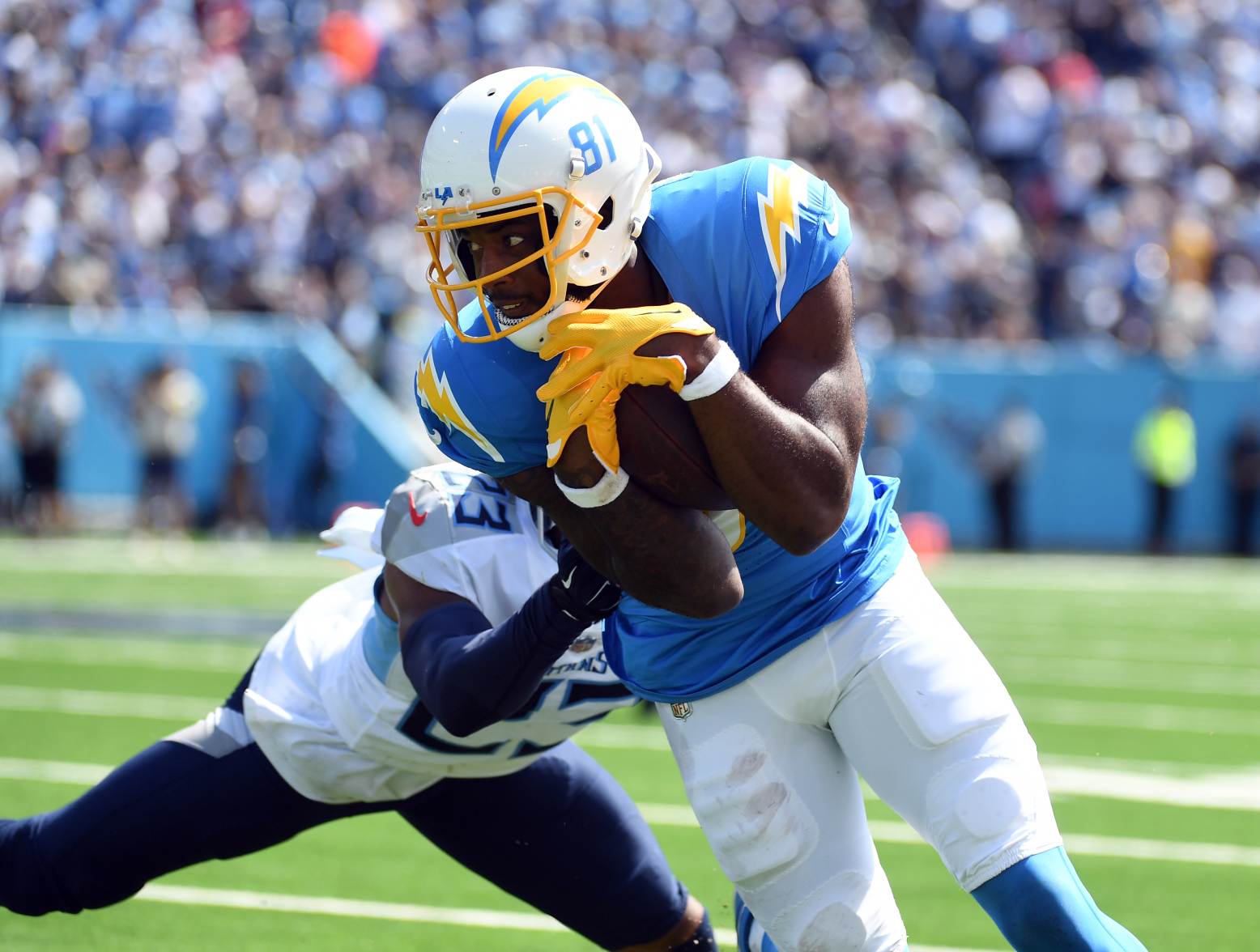 Sep 17, 2023; Nashville, Tennessee, USA; Los Angeles Chargers wide receiver Mike Williams (81) runs after a reception against Tennessee Titans cornerback Tre Avery (23) during the first half at Nissan Stadium. Credit: Christopher Hanewinckel-USA TODAY Sports