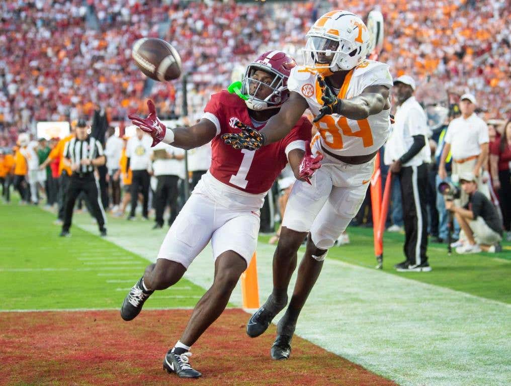 Tennessee wide receiver Kaleb Webb (84) reaches for the ball while defended by Alabama defensive back Kool-Aid McKinstry (1) during a football game between Tennessee and Alabama at Bryant-Denny Stadium in Tuscaloosa, Ala., on Saturday, Oct. 21, 2023. (Brianna Paciorka/News Sentinel/USA TODAY Network)