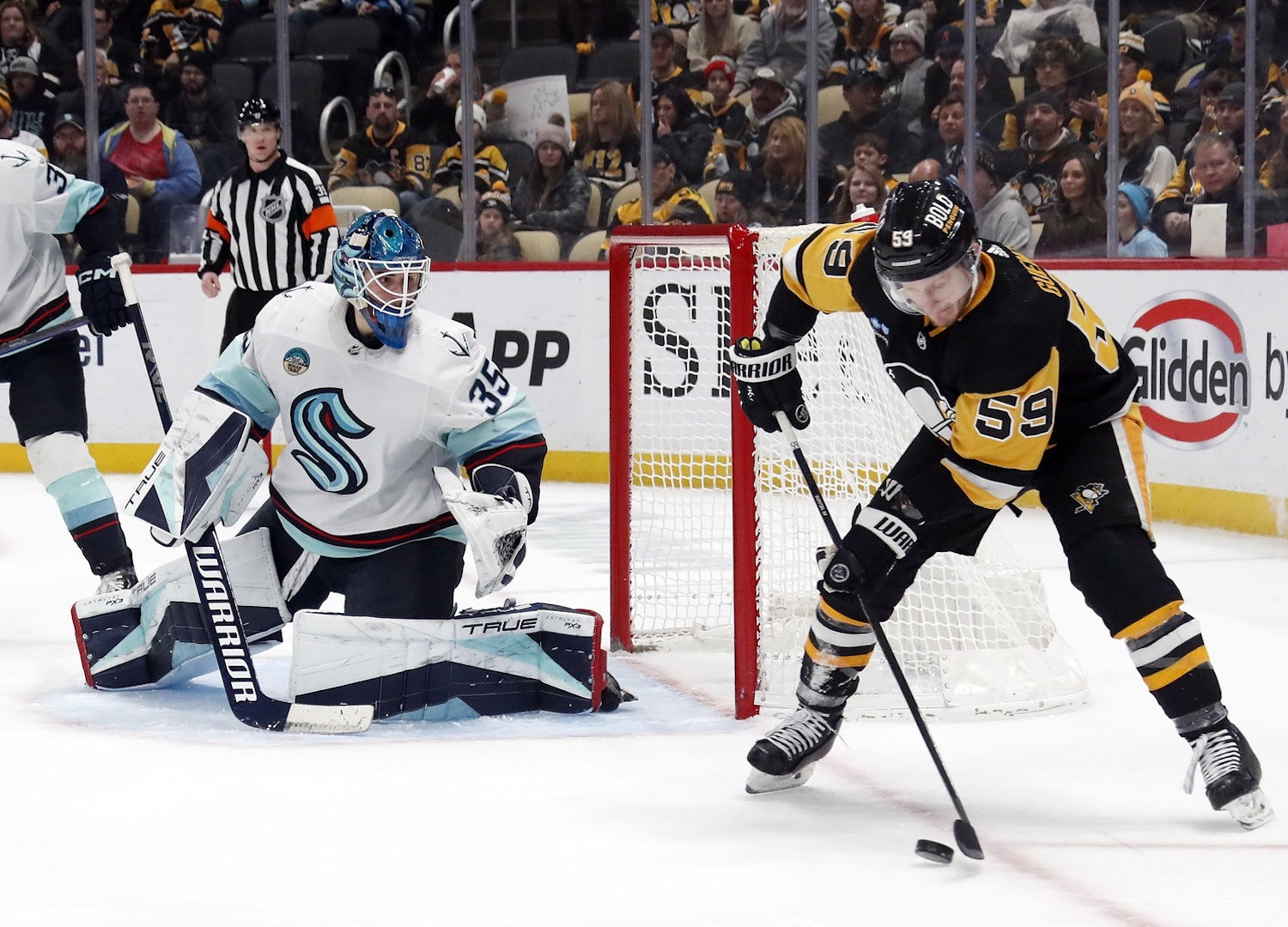 Jan 15, 2024; Pittsburgh, Pennsylvania, USA; Seattle Kraken goaltender Joey Daccord (35) defends the net against Pittsburgh Penguins left wing Jake Guentzel (59) during the third period at PPG Paints Arena. Mandatory Credit: Charles LeClaire-USA TODAY Sports