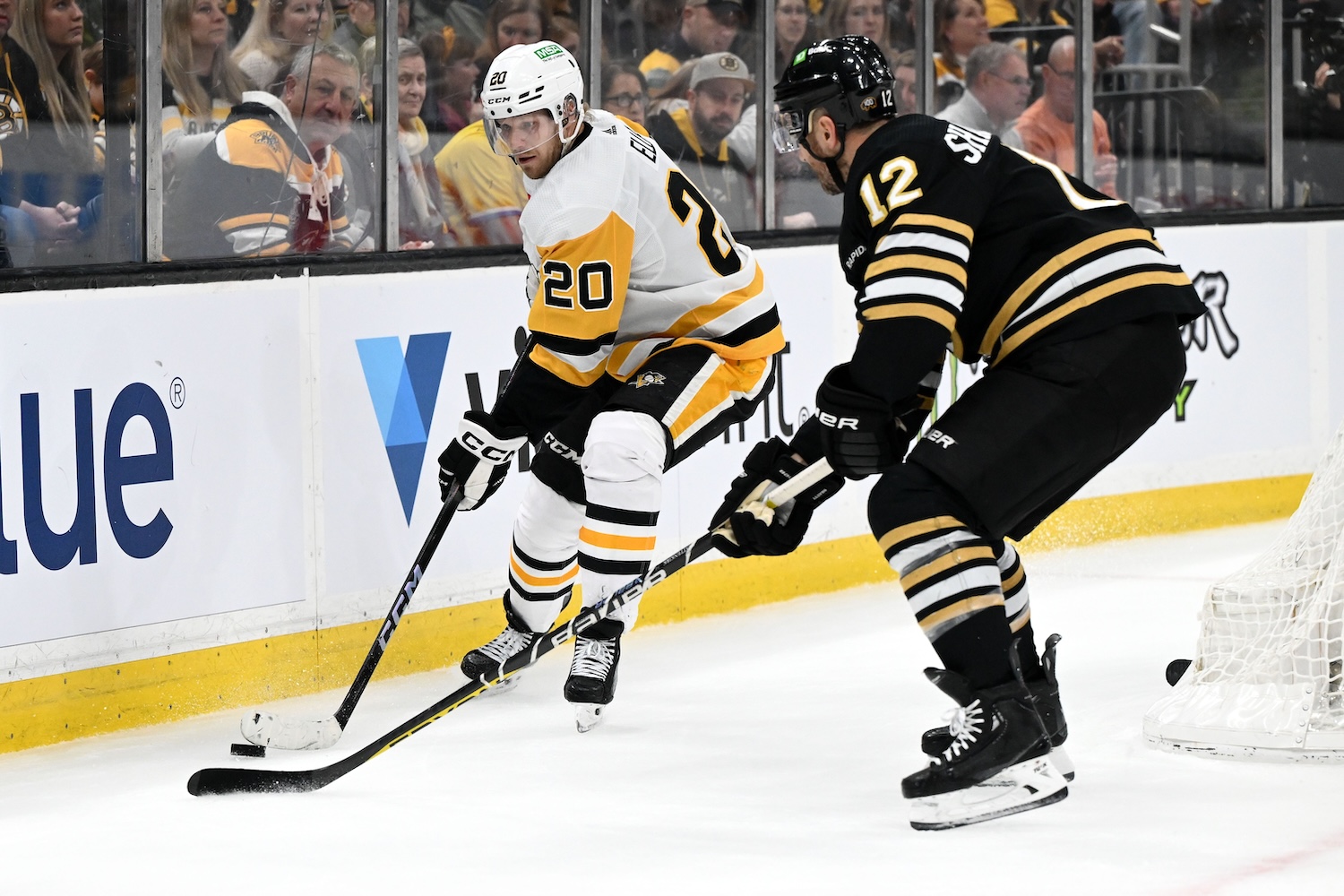 Mar 9, 2024; Boston, Massachusetts, USA; Pittsburgh Penguins center Lars Eller (20) controls the puck against Boston Bruins defenseman Kevin Shattenkirk (12) during the second period at the TD Garden. Mandatory Credit: Brian Fluharty-USA TODAY Sports