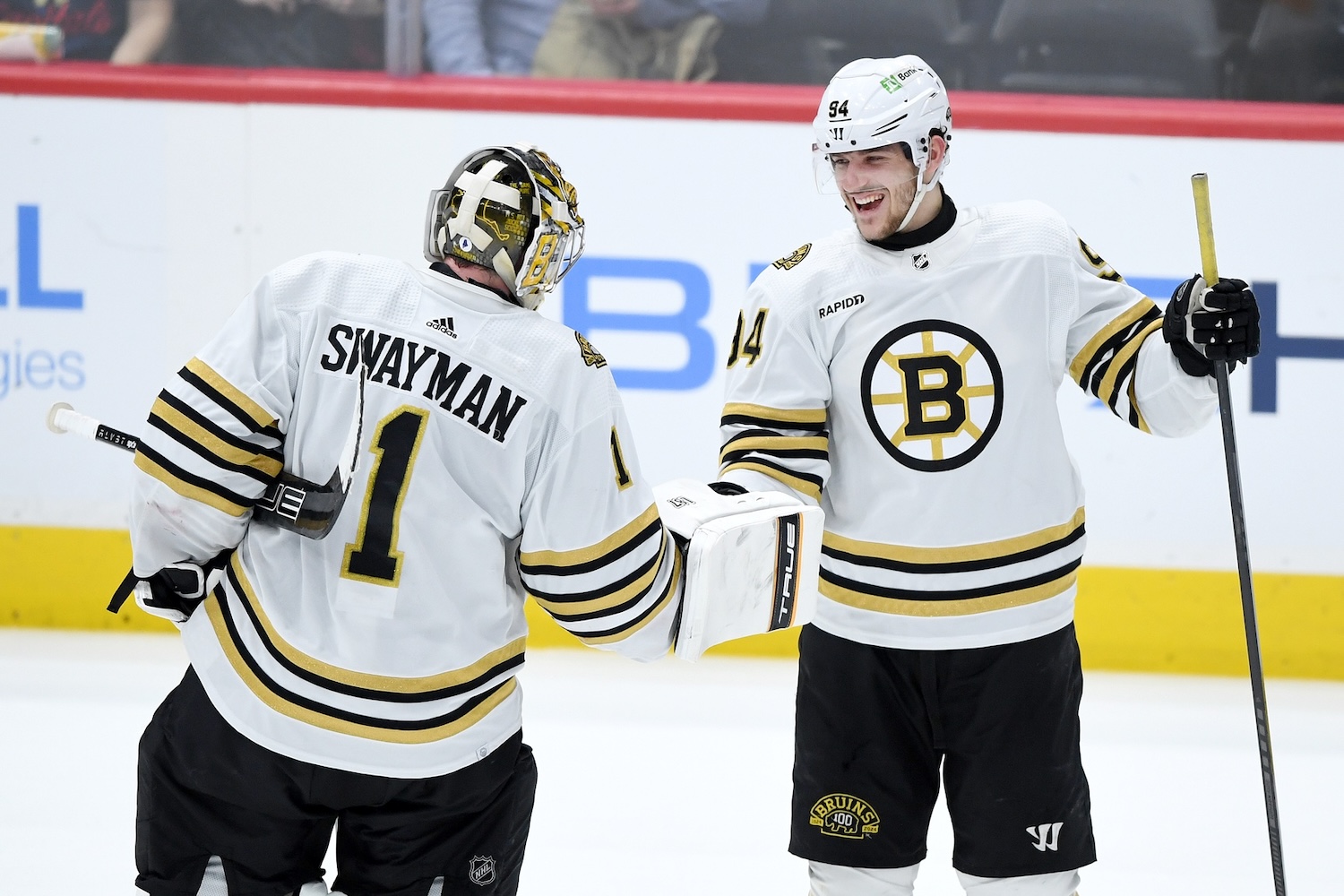 Mar 30, 2024; Washington, District of Columbia, USA; Boston Bruins goalie Jeremy Swayman (1) and center Jakub Lauko (94) celebrate after defeating the Washington Capitals in a shootout at Capital One Arena. Mandatory Credit: Hannah Foslien-USA TODAY Sports