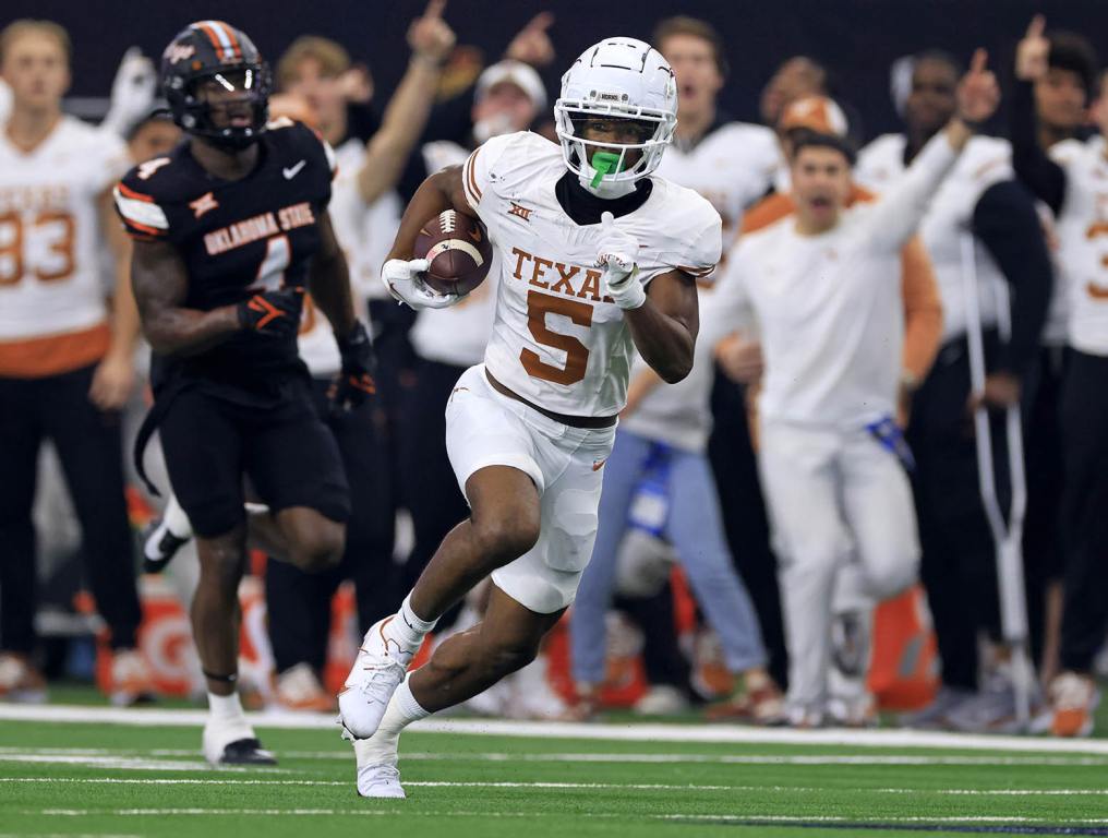 ARLINGTON, TX - DECEMBER 2: Wide receiver Adonai Mitchell #5 of the Texas Longhorns carries the ball against the Oklahoma State Cowboys in the first half of the Big 12 Championship at AT&T Stadium on December 2, 2023 in Arlington, Texas. (Photo by Ron Jenkins/Getty Images)