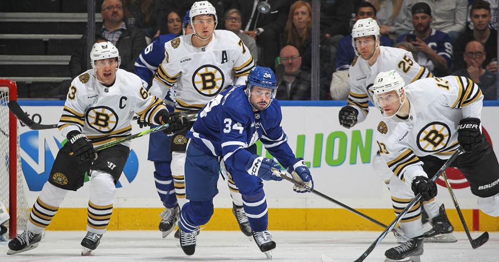 TORONTO, CANADA - MARCH 4: Auston Matthews #34 of the Toronto Maple Leafs keeps an eye on a high puck with Charlie Coyle #13 of the Boston Bruins during the first period in an NHL game at Scotiabank Arena on March 4, 2024 in Toronto, Ontario, Canada. The Bruins defeated the Maple Leafs 4-1. (Photo by Claus Andersen/Getty Images)