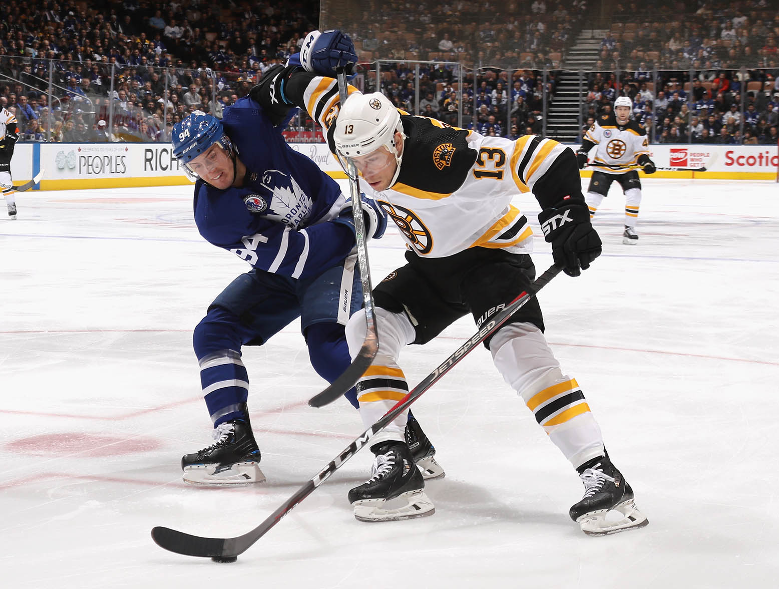 TORONTO, ONTARIO - NOVEMBER 15: Charlie Coyle #13 of the Boston Bruins attempts to get around Tyson Barrie #94 of the Toronto Maple Leafs during the first period at the Scotiabank Arena on November 15, 2019 in Toronto, Ontario, Canada. (Photo by Bruce Bennett/Getty Images)