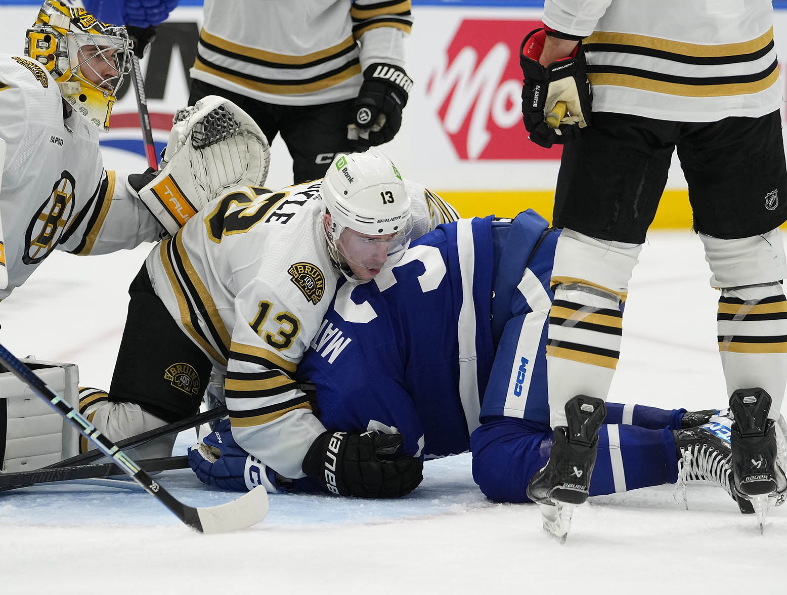 Mar 4, 2024; Toronto, Ontario, CAN; Boston Bruins forward Charlie Coyle (13) holds Toronto Maple Leafs forward Auston Matthews (34) down on the ice after a scramble for a rebound in front of Boston Bruins goaltender Jeremy Swayman (1) during the third period at Scotiabank Arena. Mandatory Credit: John E. Sokolowski-USA TODAY Sports