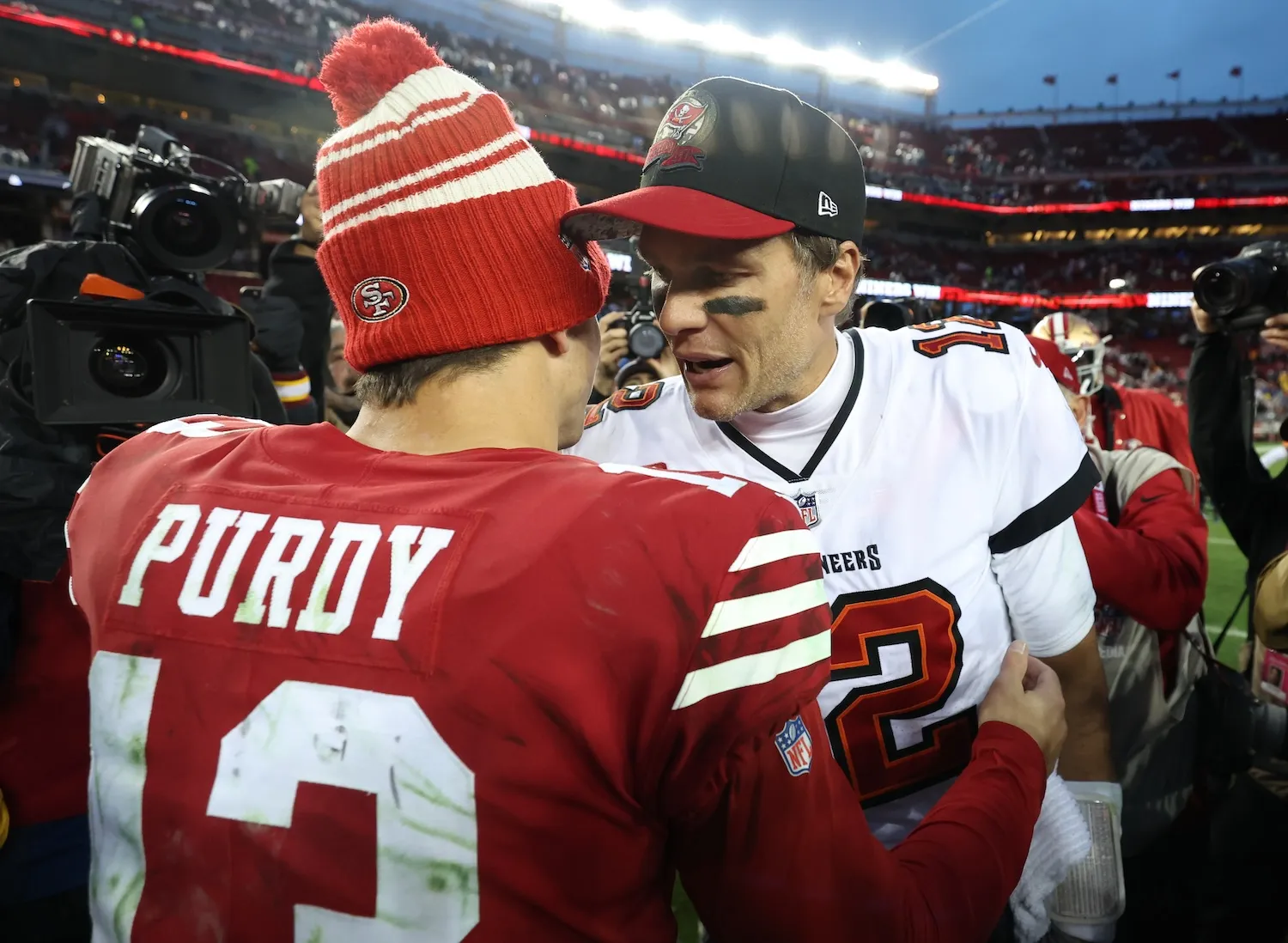 SANTA CLARA, CALIFORNIA - DECEMBER 11: Brock Purdy #13 of the San Francisco 49ers talks with Tom Brady #12 of the Tampa Bay Buccaneers following the game at Levi's Stadium on December 11, 2022 in Santa Clara, California. San Francisco defeated Tampa Bay 35-7. (Photo by Lachlan Cunningham/Getty Images)
