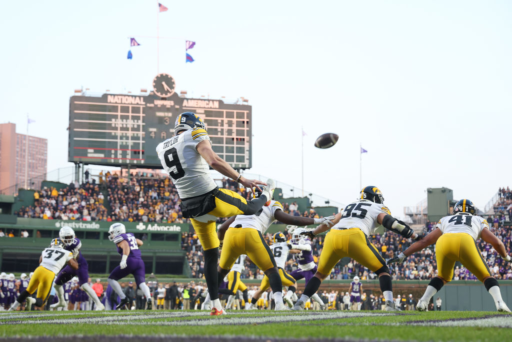 CHICAGO, ILLINOIS - NOVEMBER 04: Tory Taylor #9 of the Iowa Hawkeyes punts against the Northwestern Wildcats during the second half at Wrigley Field on November 04, 2023 in Chicago, Illinois. (Photo by Michael Reaves/Getty Images)