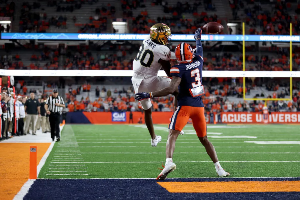 SYRACUSE, NEW YORK - NOVEMBER 25: Jahmal Banks #80 of the Wake Forest Demon Deacons attempts to catch a pass as Isaiah Johnson #3 of the Syracuse Orange defends him during the fourth quarter at JMA Wireless Dome on November 25, 2023 in Syracuse, New York. Johnson was called for pass interference on the play. (Photo by Bryan M. Bennett/Getty Images)