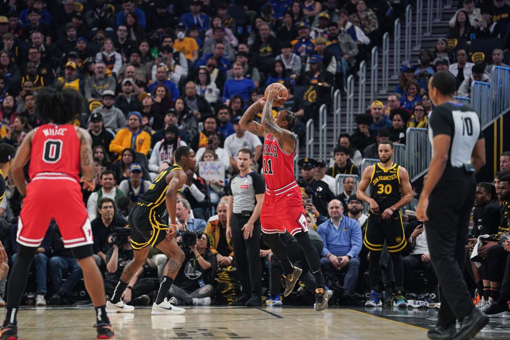 SAN FRANCISCO, CA - MARCH 7: DeMar DeRozan #11 of the Chicago Bulls goes up for a three-point jump shot against Jonathan Kuminga #00 of the Golden State Warriors in the first quarter at Chase Center on March 7, 2024 in San Francisco, California. (Photo by Kavin Mistry/Getty Images)
