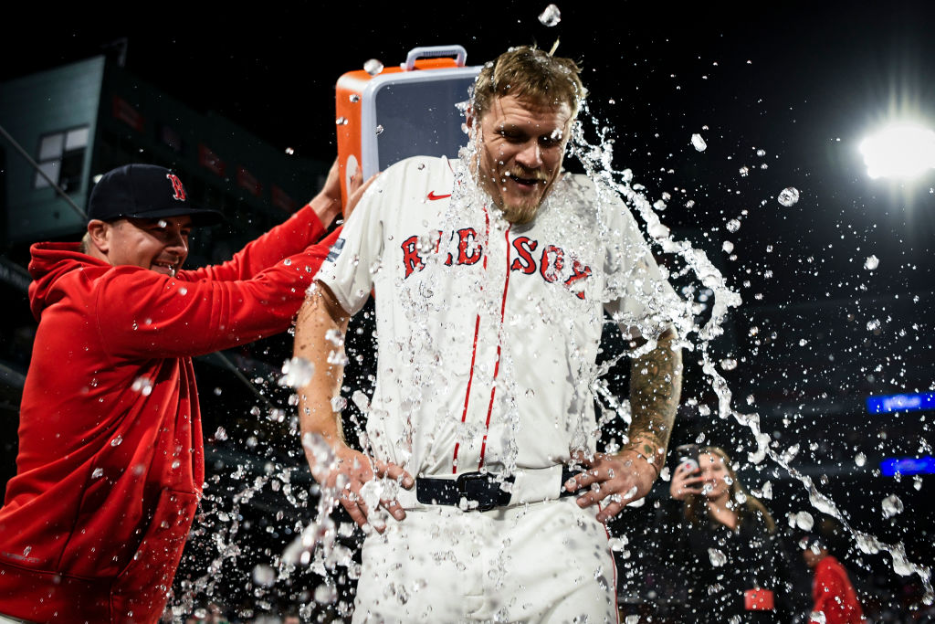 BOSTON, MASSACHUSETTS - APRIL 17: Reese McGuire #3 of the Boston Red Sox, left, dumps water on Tanner Houck #89 of the Boston Red Sox after throwing a complete game against the Cleveland Guardians at Fenway Park on April 17, 2024 in Boston, Massachusetts. (Photo by Jaiden Tripi/Getty Images)