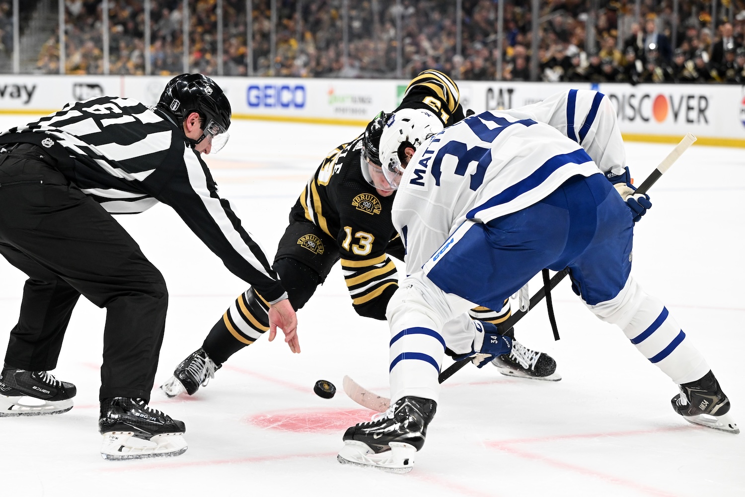 BOSTON, MASSACHUSETTS - APRIL 20: Auston Matthews #34 of the Toronto Maple Leafs and Charlie Coyle #13 of the Boston Bruins take a face-off in the Maple Leafs zone during the first period in Game One of the First Round of the 2024 Stanley Cup Playoffs at TD Garden on April 20, 2024 in Boston, Massachusetts. (Photo by Brian Fluharty/Getty Images)