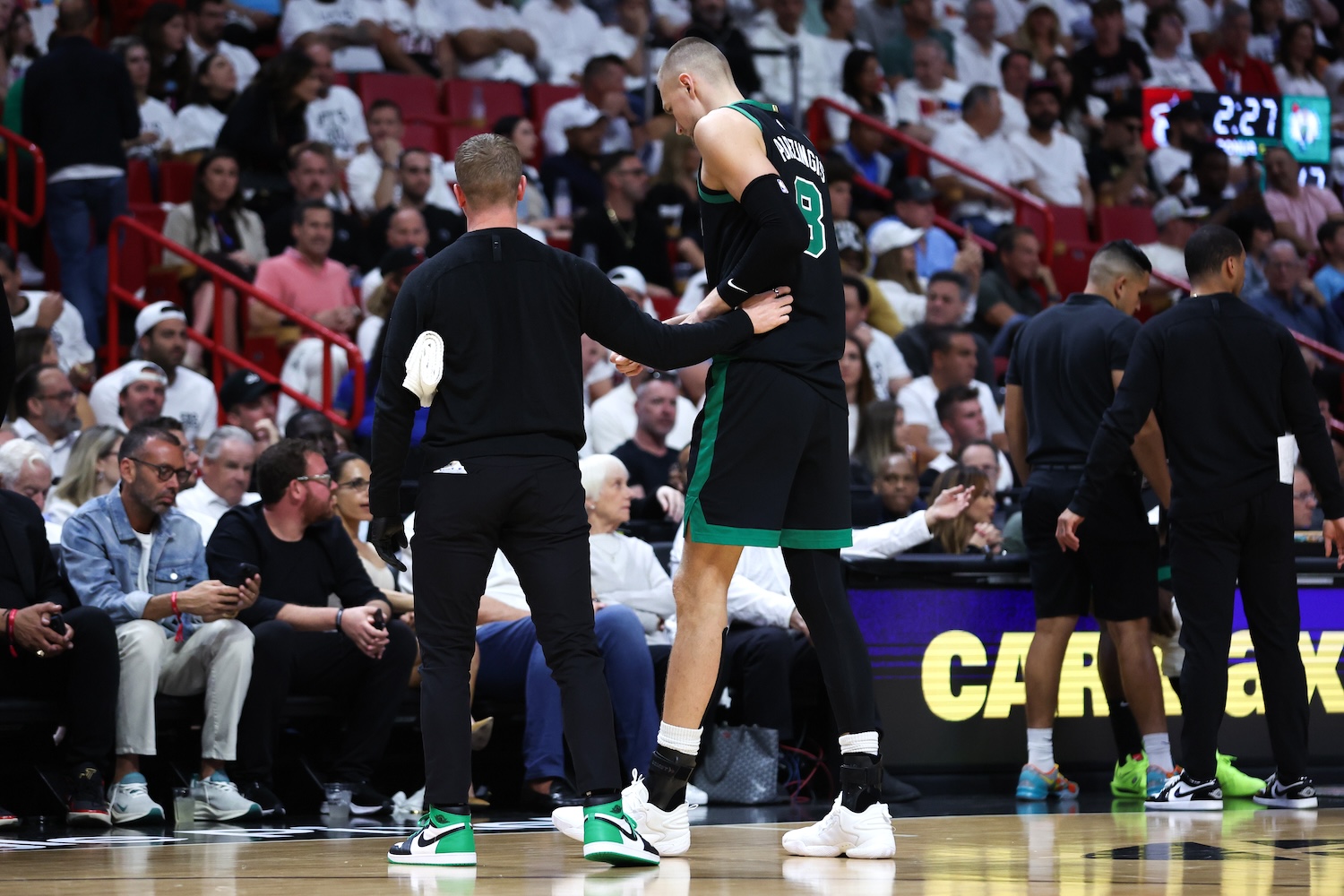 MIAMI, FLORIDA - APRIL 29: Kristaps Porzingis #8 of the Boston Celtics leaves the game against the Miami Heat during the second quarter after suffering an apparent injury in game four of the Eastern Conference First Round Playoffs at Kaseya Center on April 29, 2024 in Miami, Florida. NOTE TO USER: User expressly acknowledges and agrees that, by downloading and or using this photograph, User is consenting to the terms and conditions of the Getty Images License Agreement. (Photo by Megan Briggs/Getty Images)