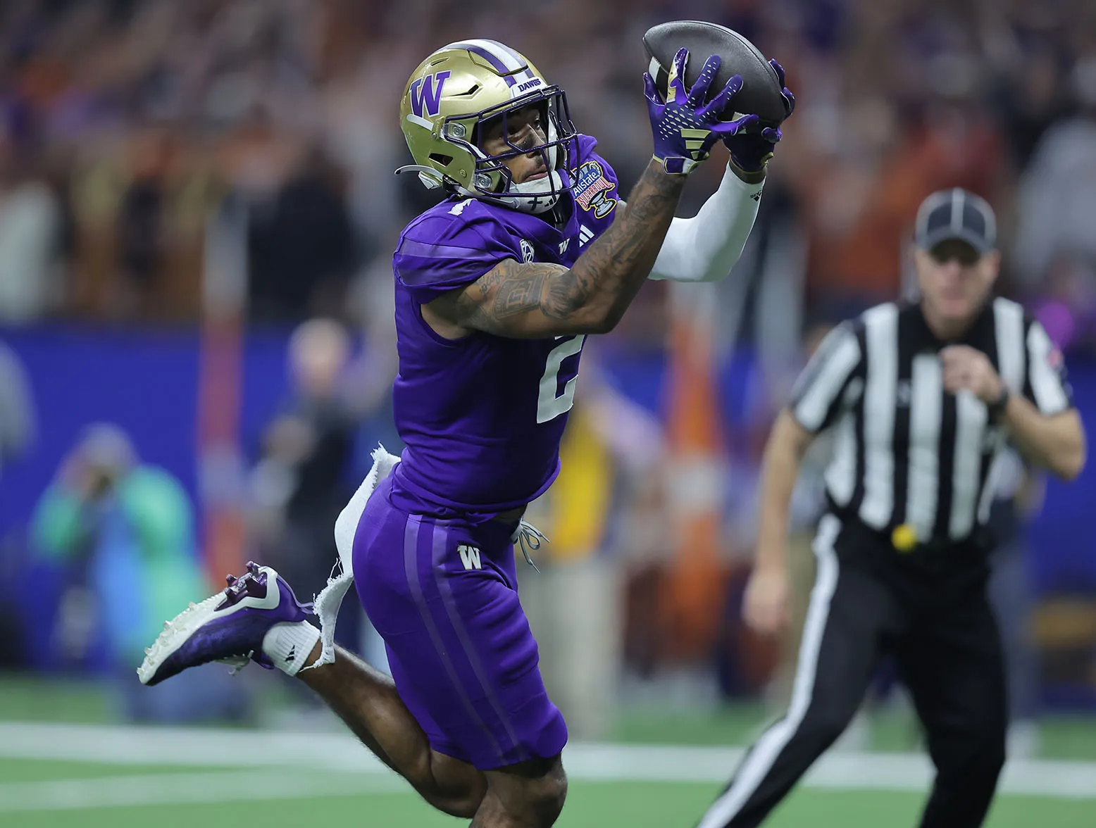 NEW ORLEANS, LOUISIANA - JANUARY 01: Ja'Lynn Polk #2 of the Washington Huskies catches a touchdown pass during the second quarter against the Texas Longhorns during the CFP Semifinal Allstate Sugar Bowl at Caesars Superdome on January 01, 2024 in New Orleans, Louisiana. (Photo by Jonathan Bachman/Getty Images)