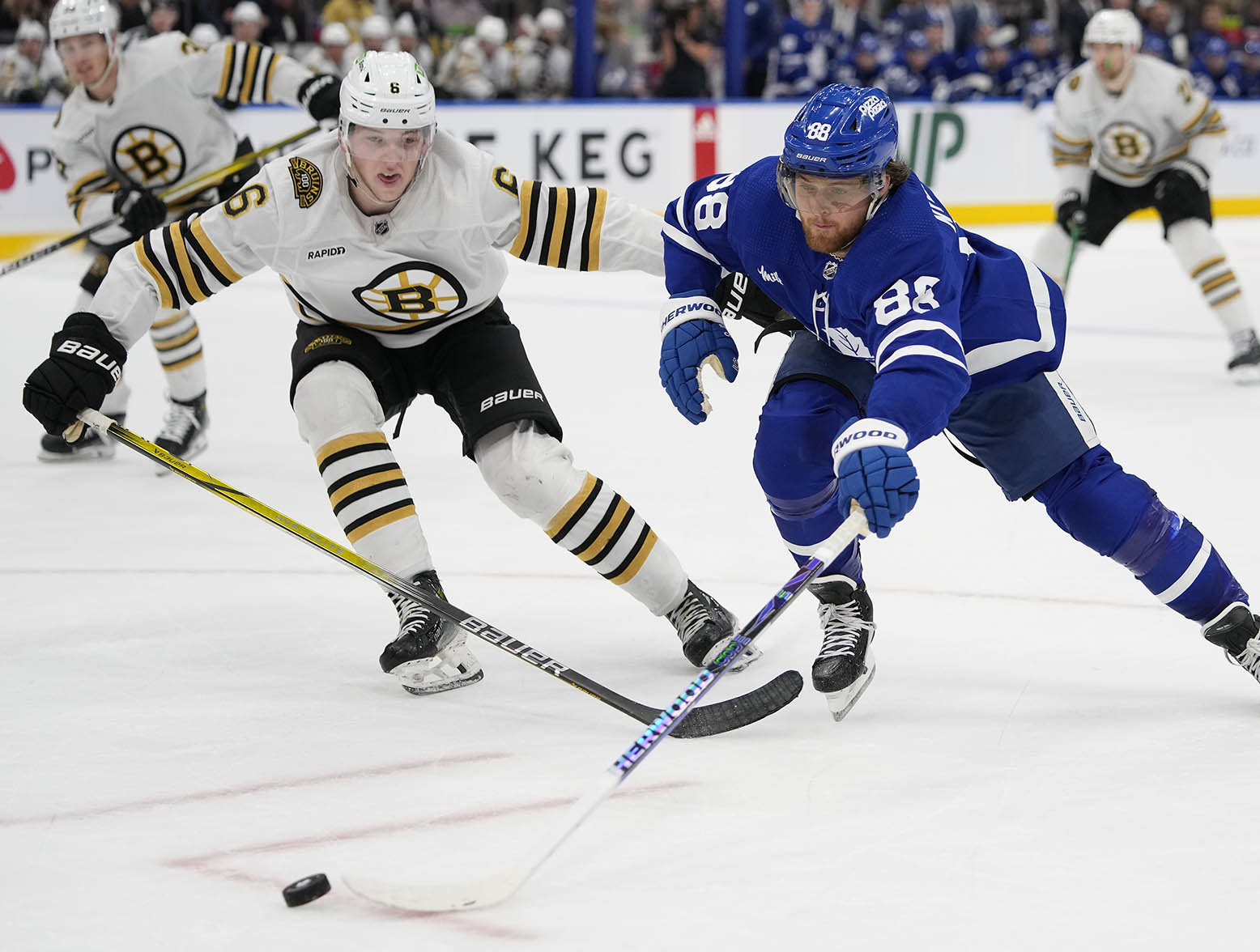 Mar 4, 2024; Toronto, Ontario, CAN; Toronto Maple Leafs forward William Nylander (88) tries to get control of a puck as Boston Bruins defenseman Mason Lohrei (6) defends during the third period at Scotiabank Arena. Mandatory Credit: John E. Sokolowski-USA TODAY Sports