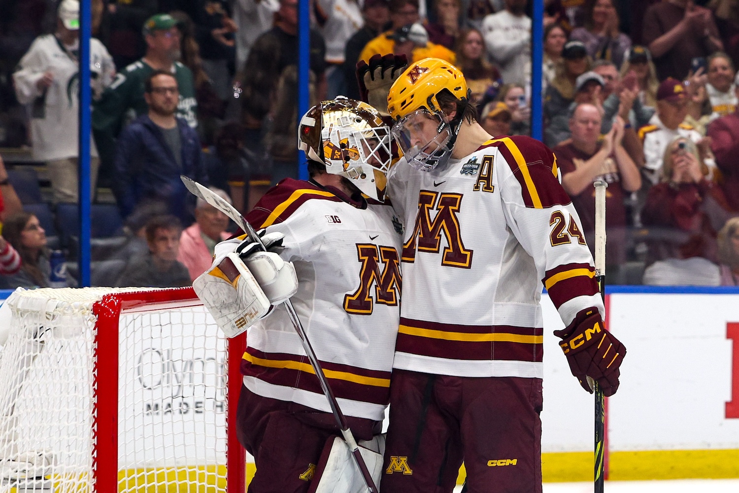 Apr 6, 2023; Tampa, Florida, USA; Minnesota forward Jaxon Nelson (24) congratulates goaltender Justen Close (1) after beating Boston University in the semifinals of the 2023 Frozen Four college ice hockey tournament at Amalie Arena. Mandatory Credit: Nathan Ray Seebeck-USA TODAY Sports