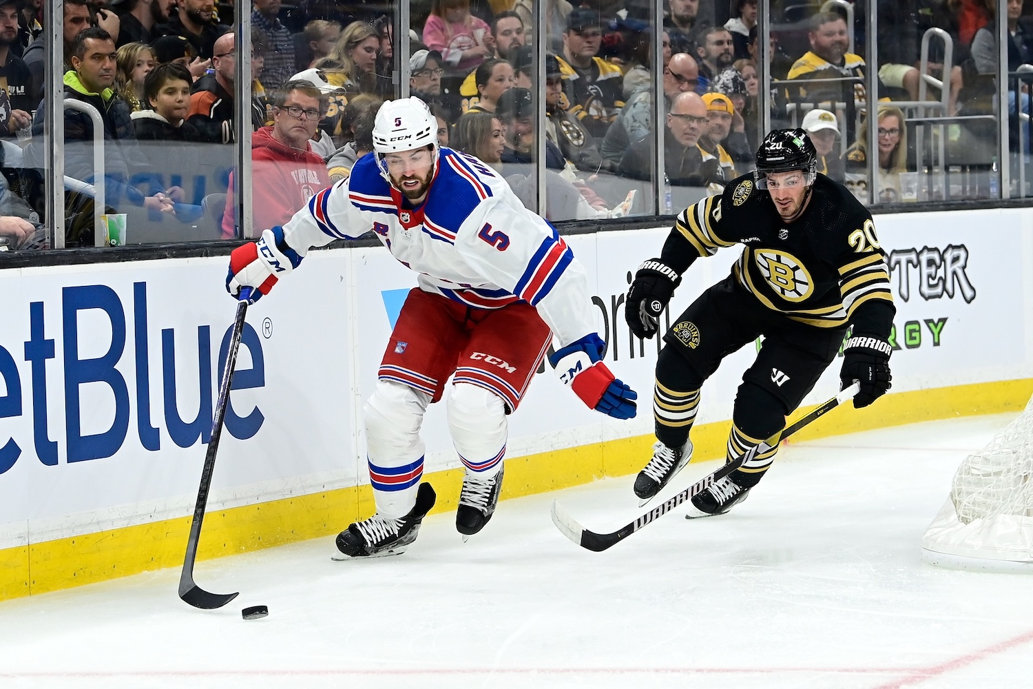 Sep 24, 2023; Boston, Massachusetts, USA; New York Rangers defenseman Ben Harpur (5) controls the puck in front of Boston Bruins center Jayson Megna (20) during the first period at TD Garden. Mandatory Credit: Eric Canha-USA TODAY Sports