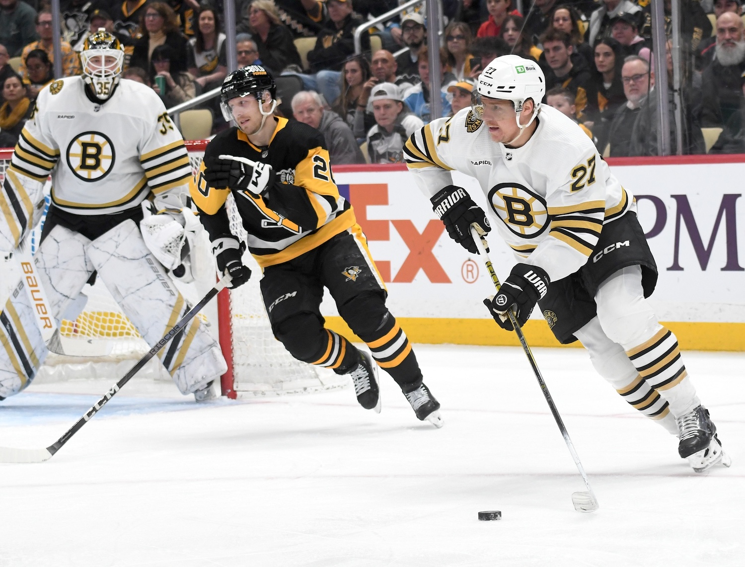 Apr 13, 2024; Pittsburgh, Pennsylvania, USA; Boston Bruins defenseman Hampus Lindholm (27) moves the puck past Pittsburgh Penguins center Lars Eller (20) during the first period at PPG Paints Arena. Mandatory Credit: Philip G. Pavely-USA TODAY Sports