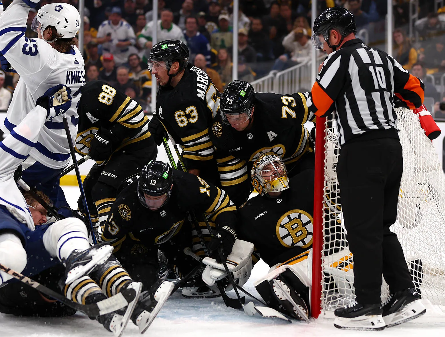 BOSTON, MASSACHUSETTS - APRIL 30: Jeremy Swayman #1 of the Boston Bruins looks to referee Kyle Rehman as members of the Boston Bruins and Toronto Maple Leafs collide in front of the goal during the second period of Game Five of the First Round of the 2024 Stanley Cup Playoffs at TD Garden on April 30, 2024 in Boston, Massachusetts. (Photo by Maddie Meyer/Getty Images)